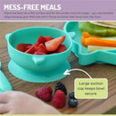 Silicone suction bowl in shark blue with strawberries, demonstrating mess-free feeding, alongside fresh berries.
