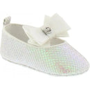 White Michael Kors baby girl crib shoe with an iridescent sheen and a large white bow on the front.