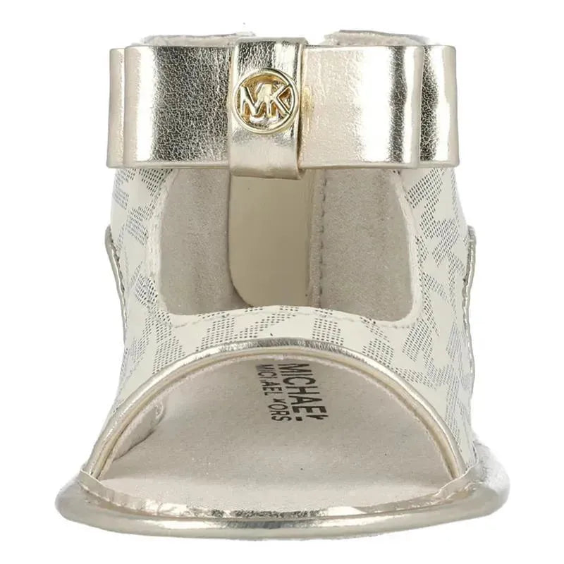 Crib shoes by Michael Kors in vanilla mono with a metallic gold bow and logo, featuring an open-toe design.