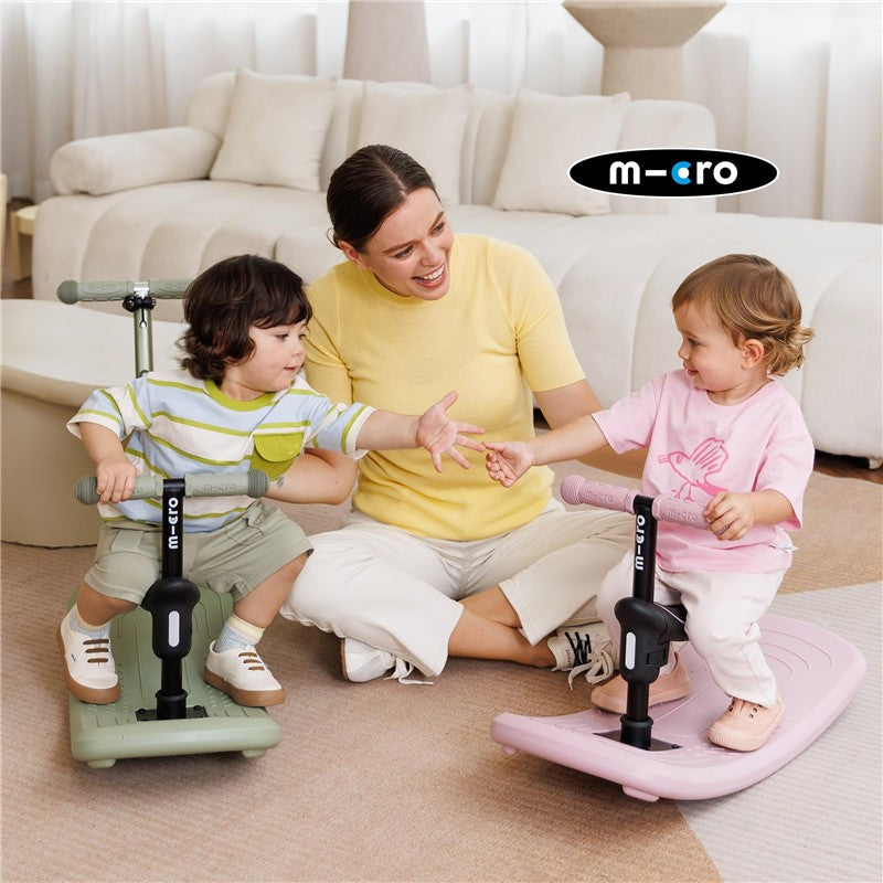 Children play and interact while using the Micro Kickboard Mini Rock & Go LED scooters in a comfortable indoor setting.