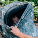 Milk Snob Disney 5-in-1 multifunctional cover featuring Tinker Bell design, partially covering a sleeping baby in a stroller.