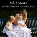 Soft and secure baby blanket featuring colorful floral patterns, used by a mother with two young daughters outdoors.