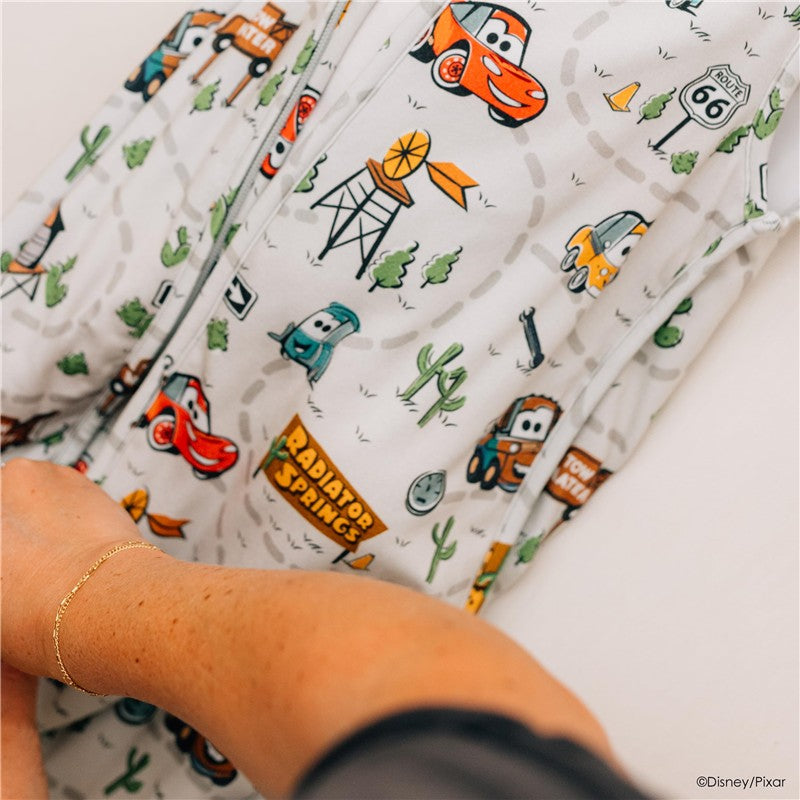 Milk Snob Disney and Pixar Cars Baby Sleep Bag featuring colorful characters and a Radiator Springs theme, suitable for babies 0–6 months.