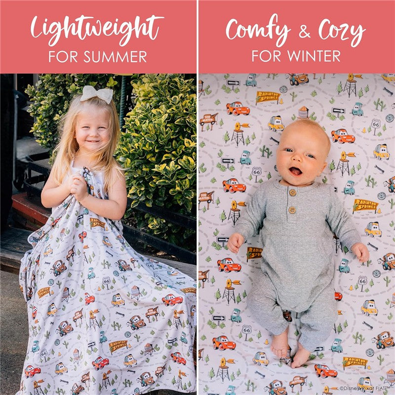Milk Snob Disney and Pixar Cars swaddle blanket, featuring colorful cartoon cars on a white background, shown with a girl and baby.