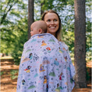 Baby blanket featuring Disney Princesses, wrapped around a smiling woman holding an infant outdoors.