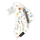 Soft white baby security blanket with colorful floral prints and an attached pacifier, branded Milk Snob.