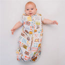 Baby smiling while wearing a colorful Milk Snob Marvel World Baby Sleep Bag with superhero graphics, suitable for 0-6 months.