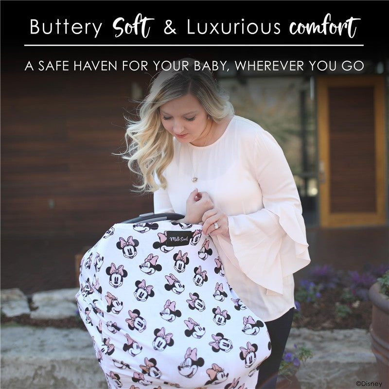 Minnie Mouse patterned cover being held by a woman, promoting comfort and safety for babies.