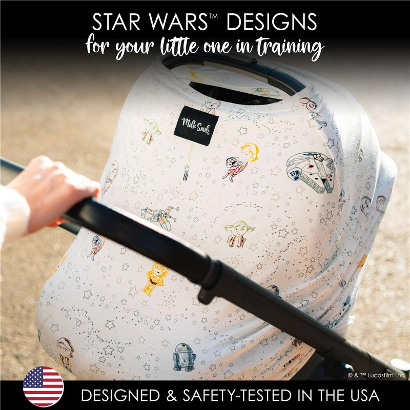 Multifunctional cover featuring Star Wars™ characters on a light background, draped over a stroller handle.