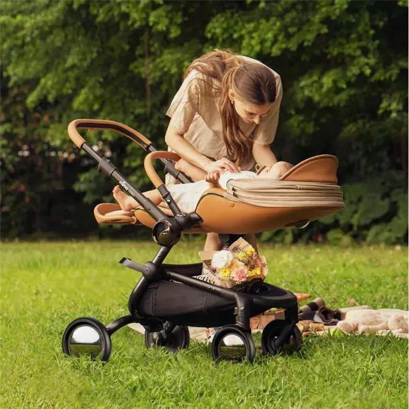 Mima Creo Single Stroller in Mocha Cream; a woman gently caring for a baby in the stroller on grass.
