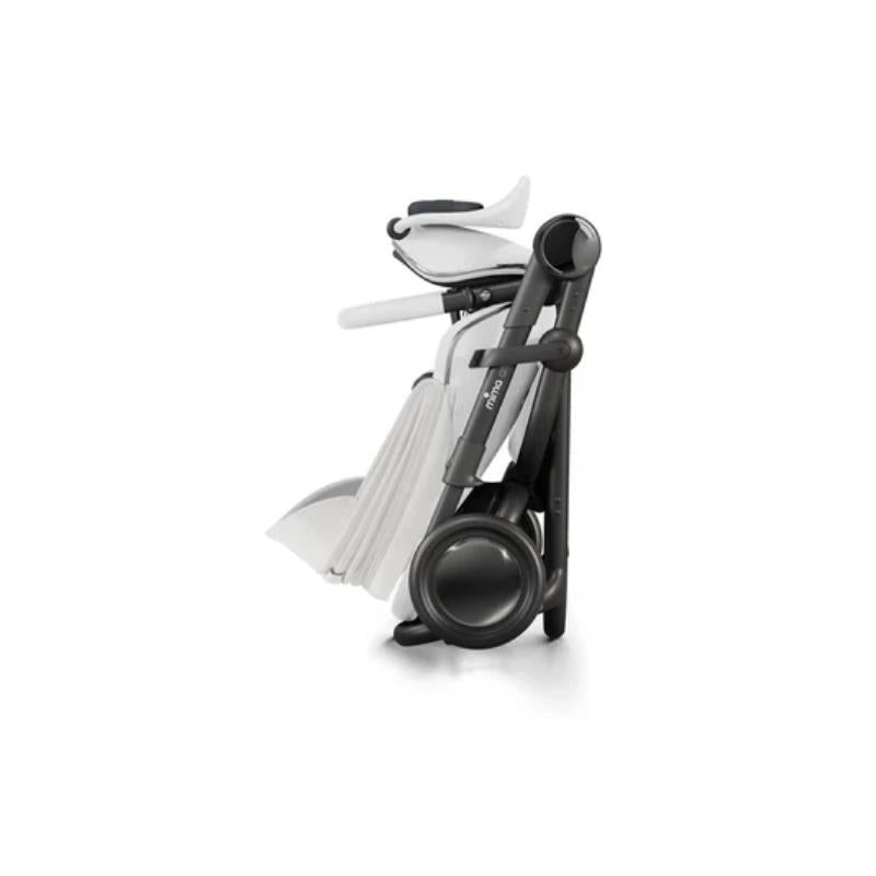 Mima Creo Single Stroller in white, folded for easy storage, displaying sleek lines and modern design.