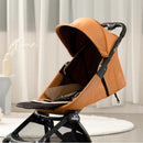 Mima Miro compact stroller with a black chassis and mocha cream seat, featuring a stylish canopy and safety harness.