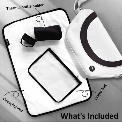 Trendy black Mima diaper bag with included changing mat and thermal bottle holder, displayed on a light background.