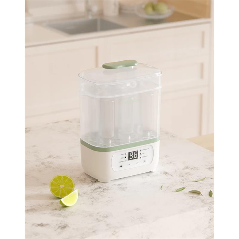8-in-1 Baby Bottle Steam Sterilizer on a countertop, featuring a digital display and a partially transparent design.