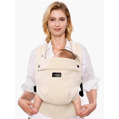Momcozy baby carrier in light amber, showcasing a woman holding a young child comfortably secured in the carrier.