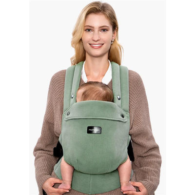 Momcozy baby carrier in sage green, worn by a smiling woman, holding a baby securely in front.