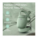 Sage green Momcozy baby carrier made of premium cotton-linen, highlighting softness, breathability, and eco-friendliness.