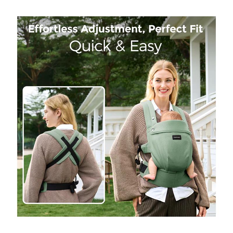 Baby carrier in sage green worn by a smiling woman, highlighting its effortless adjustment and comfort.