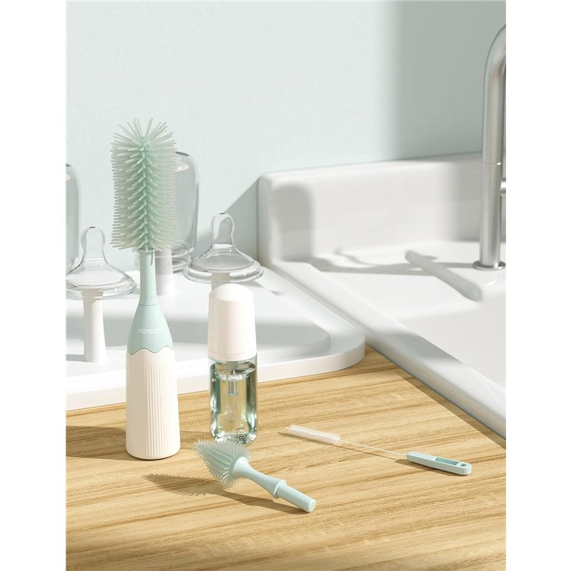 Momcozy Bottle Brush Kit, featuring a green bottle brush, bottle cleaner, and cleaning solution on a wooden countertop.