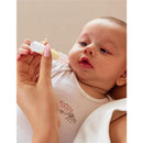 Momcozy Colostrum Reusable Breast Milk Collector held by a caregiver, with a focused baby observing it.