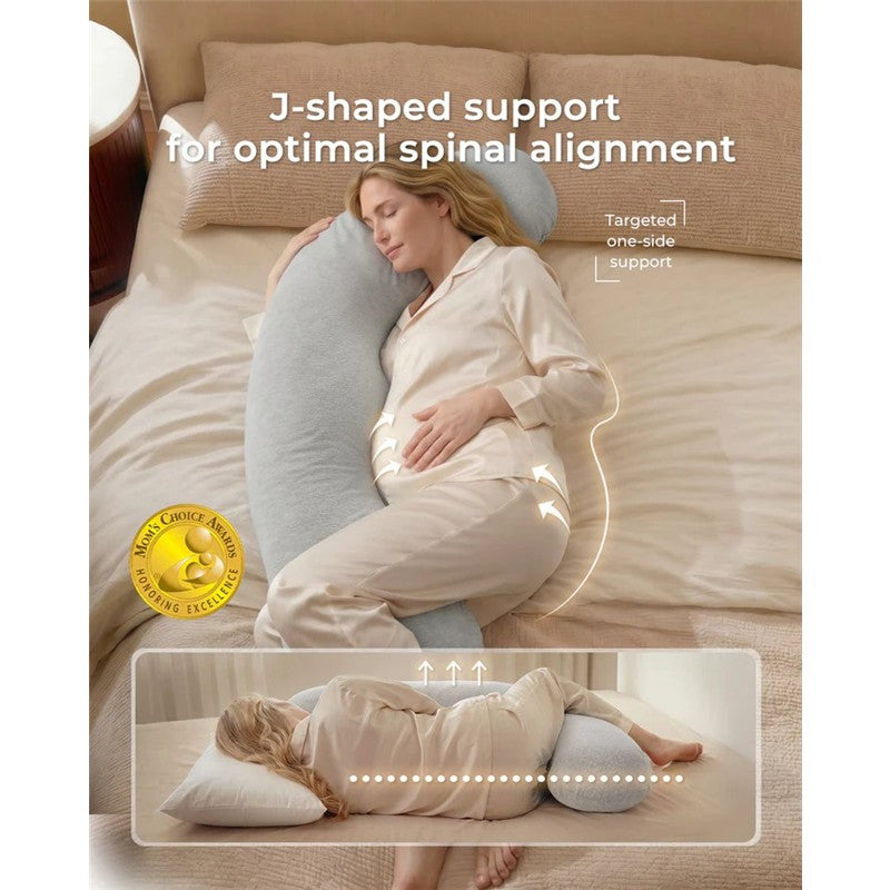 J-shaped maternity body pillow providing targeted support for spinal alignment, with a woman relaxing beside it.