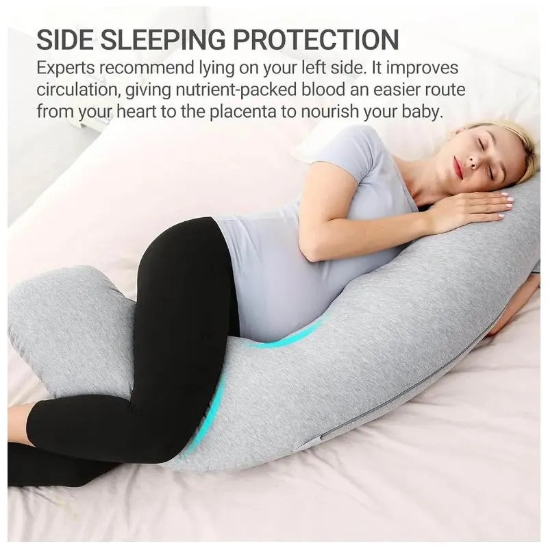 Pregnant woman resting peacefully with a gray J-shaped maternity body pillow, promoting side sleeping for better circulation.