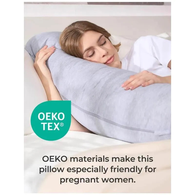 J-shaped gray maternity body pillow with a woman resting her head on it, promoting comfort for pregnant women using OEKO-TEX materials.