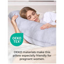 J-shaped gray maternity body pillow with a woman resting her head on it, promoting comfort for pregnant women using OEKO-TEX materials.