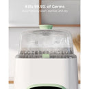 Momcozy KleanPal Pro Baby Bottle Washer and Sterilizer, with a clear top and visible water mist, highlights germ-killing efficiency.