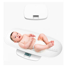 Multi-function baby scale with an infant lying on it, displaying a weight of 2.00 kg on a digital screen.