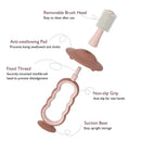 Pink Momcozy toothbrush featuring a removable brush head, anti-swallowing pad, non-slip grip, and suction base for easy storage.