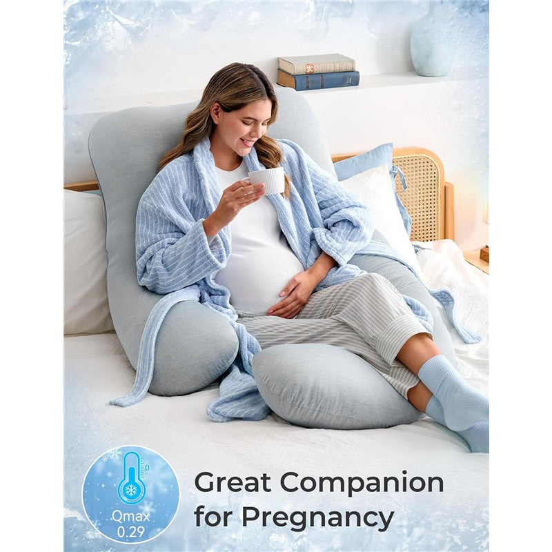 U-shaped cooling fabric pregnancy pillow supporting a smiling pregnant woman enjoying tea in a cozy setting.
