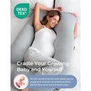Pregnant woman relaxing with a gray U-shaped pregnancy pillow, promoting comfort and support during sleep.