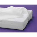 Luxury Dreamer crib mattress featuring a white, textured cover on a solid white base, set against a purple background.