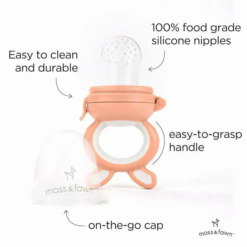 Soothing silicone baby food teething toy in light pink with a clear silicone nipple, easy-to-grasp handle, and on-the-go cap.