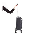 A dark gray Mountain Buggy Skyrider Luxury suitcase is being pulled by a hand gripping its retractable handle.