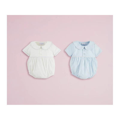 Two baby boy poplin bubble outfits in light blue and white, featuring short sleeves and Peter Pan collars, on a pink background.