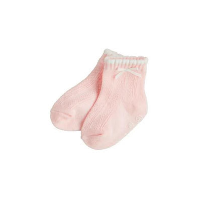 Light pink baby socks with a knitted design, ruffled top, and a small bow accent. Soft and perfect for infant girls.