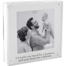 Baby handprint frame featuring a black and white photo of a smiling baby held by a man and woman, with an engraved quote.