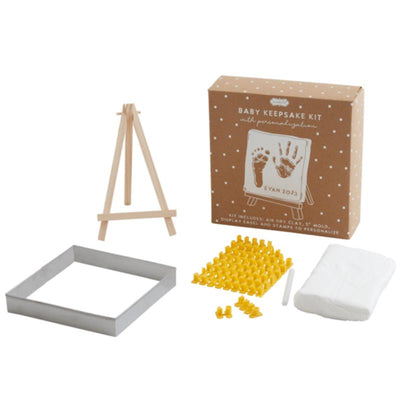 Baby Keepsake Kit by Mud Pie includes wooden easel, air dry clay, a mold, yellow stamps, and personalization options.