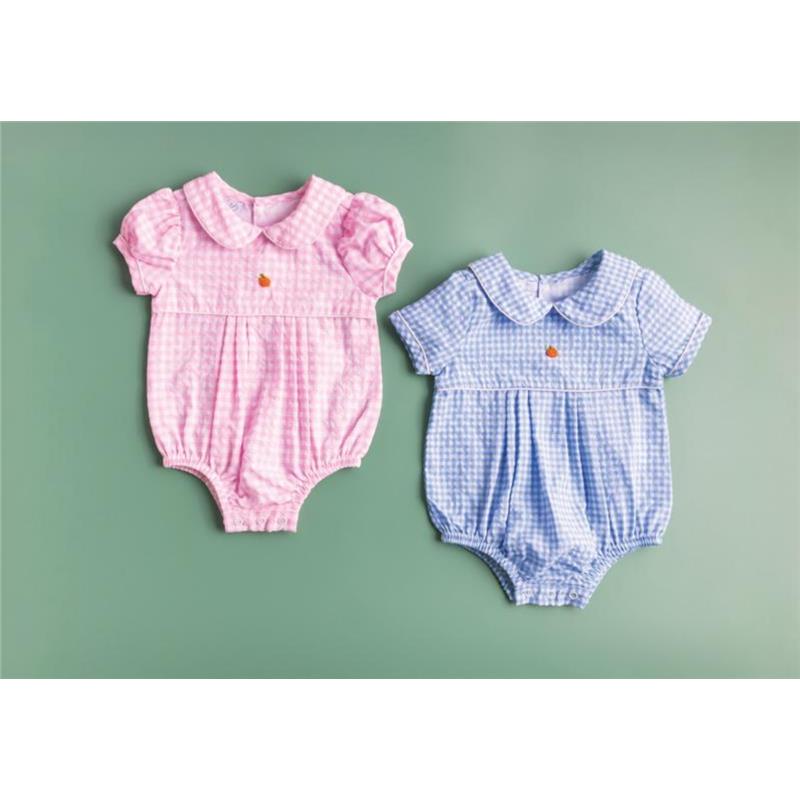 Baby pink and blue gingham bubble rompers with short puff sleeves and front button detail, displayed on a green background.