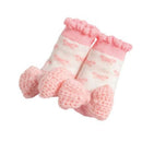 Crochet rattle toe socks in pink for infants, featuring a cute bow design at the toes and a ruffled top.