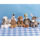 Plush animal collection featuring a cow, chicken, duck, goat, and donkey on a blue background and checkered tablecloth.