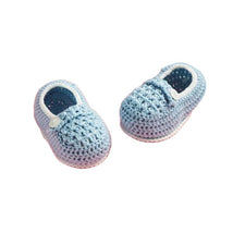 Crochet baby booties in light blue, featuring a textured pattern and a white trim with a button detail.