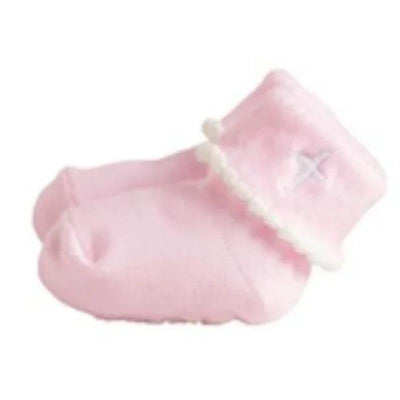 White cross foldover baby socks in pink with a decorative white pom-pom trim, size 0-6 months.