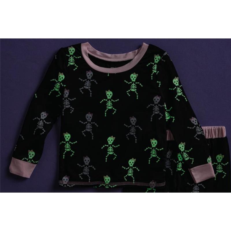 Toddler pajamas featuring a black fabric with glow-in-the-dark pink skeleton designs, including playful skeletons in various poses.