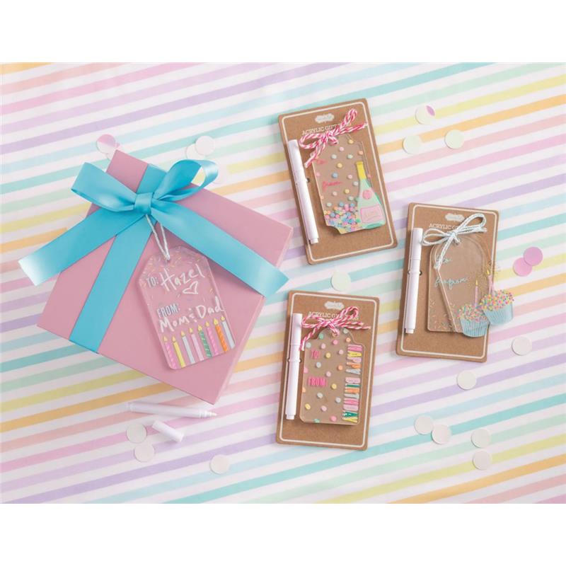 Happy Birthday acrylic tag set, featuring colorful designs and markers, displayed next to a pink gift box with blue ribbon.