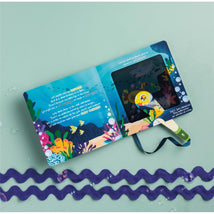 Ocean-themed interactive book featuring a flashlight and colorful marine illustrations on both pages.