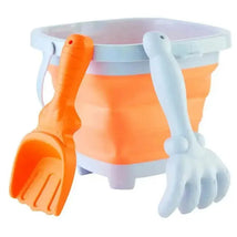 Orange collapsible bucket set with a textured orange scoop and a white claw-like grabber tool, ideal for beach or sand play.