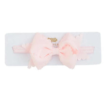 Light pink scalloped bow headband by Mud Pie, displayed on a white card.